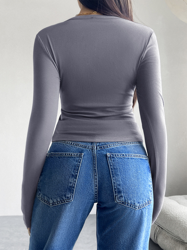 Top abotonado de color sólido, manga larga y estilo camiseta